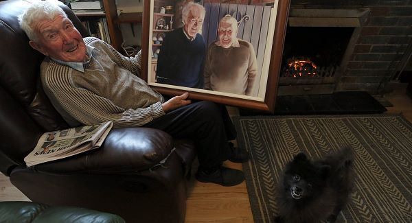 Barney Devlin (95) with a prized painting of himself and Seamus Heaney. His father is the blacksmith referred to by Heaney in The Forge.